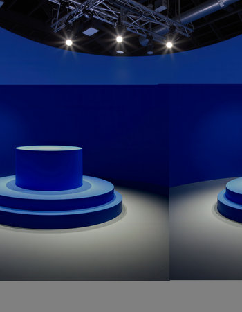 3D rendering of a round podium in a blue studio with spotlightsの素材