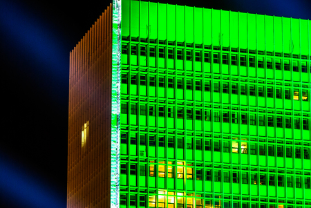horizontal image of a building with green lights at nightの写真素材