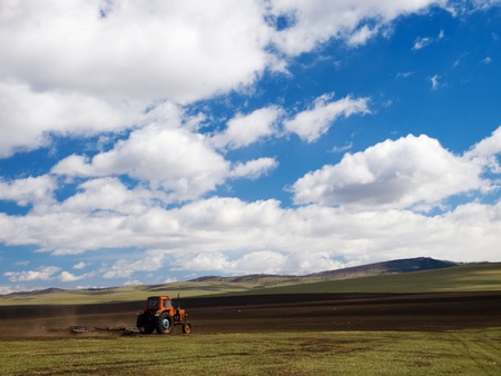 Vintage russian tractor working on mongolian field