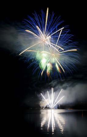 Colorful fireworks show above the lakeの写真素材