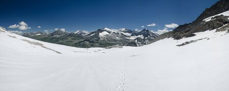 Alpine landscape with hiking trail over snow covered glacier, Hohe Tauern NP, Austria