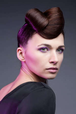 Fashion studio shot of beautiful woman with a luxurious and healthy hair on natural background ...
