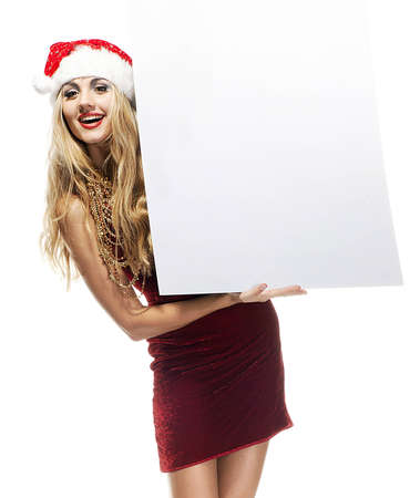 Beautiful christmas woman in Santa Clause costume with empty blank boardの写真素材