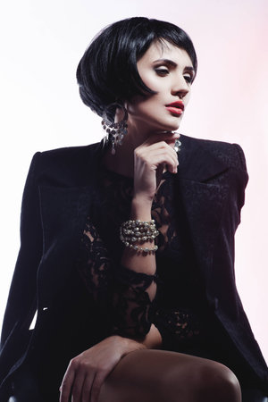 Studio shot of  Sexy Fashionl Woman in Black Guipure Dress and suit. Professional Makeup and Hairstyleの写真素材