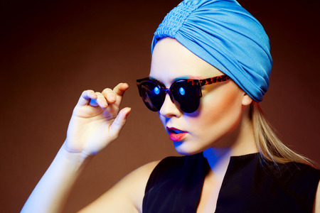 Close-up portrait of beautiful and fashion woman in sunglasses, studio shot. Professional makeup and hairstyleの写真素材