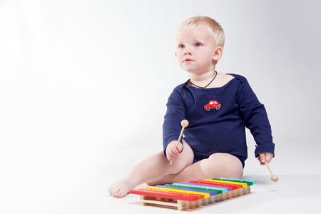 Smiling Baby boy is  playing with educational toys の写真素材