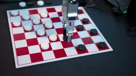 Robot playing checkers hand manipulator moves checkersの写真素材