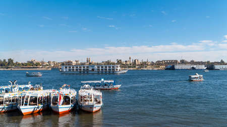 Luxor, Egypt - January 2020: Nile embankment with boats and Luxor Temple in Luxor, beautiful landscape, Egyptのeditorial素材