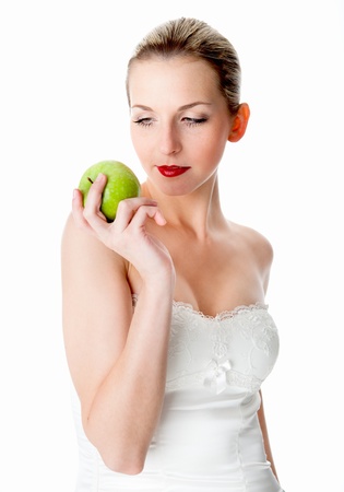 A young, beautiful woman holding a green appleの写真素材