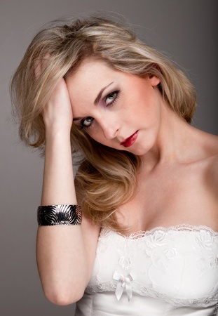 Young sexy German woman holds her headの写真素材