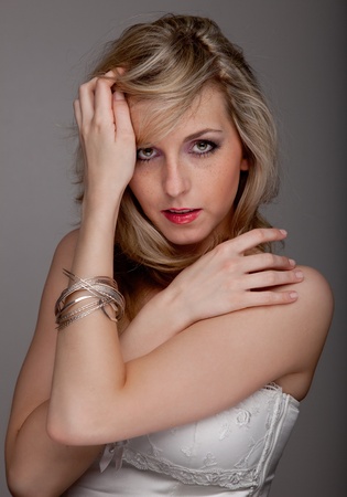 Young beautiful woman keeps her hair off her faceの写真素材