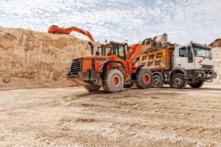 heavy vehicles at work in a limestone mine
