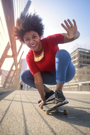 Cool woman is skateboardingの写真素材