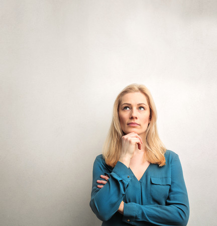 Blonde girl is planning somethingの写真素材