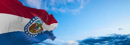 flag of Missouri at cloudy sky background on sunset. Patriotic concept about state. 3d illustrationの写真素材