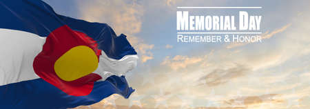 Flag of Colorado being waved in the breeze against a sunset sky and the text Memorial Day, remember...