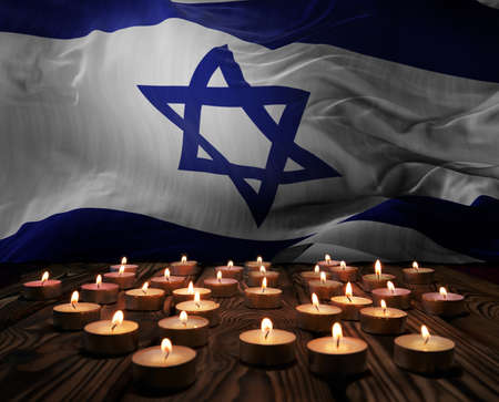 Mourning candles burning on Israel national flag of background. Memorial weekend, patriot veterans day, National Day of Service & Remembrance. Burning candles on wooden surface. 3d illustration.の写真素材