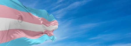 Transgender Pride   flag waving in the wind at cloudy sky. Freedom and love concept. Pride month. activism, community and freedom Concept. Copy space. 3d illustration,の写真素材
