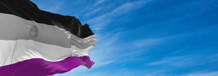 Asexual Pride   flag waving in the wind at cloudy sky. Freedom and love concept. Pride month. activism, community and freedom Concept. Copy space. 3d illustration,の写真素材