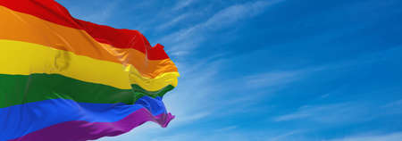 Gay Pride flag waving in the wind at cloudy sky. Freedom and love concept. Pride month. activism, community and freedom Concept. Copy space. 3d illustration,の写真素材