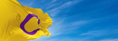 Intersex Pride flag waving in the wind at cloudy sky. Freedom and love concept. Pride month....