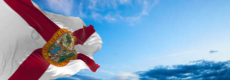 flag of Florida at cloudy sky background on sunset. Patriotic concept about state. 3d illustration.の写真素材