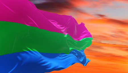 Polysexuality Pride flag waving in the wind at cloudy sky. Freedom and love concept. Pride month. activism, community and freedom Concept. Copy space. 3d illustration,の写真素材