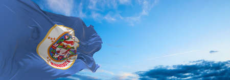 flag of Minnesota at cloudy sky background on sunset. Patriotic concept about state. 3d illustration,の写真素材
