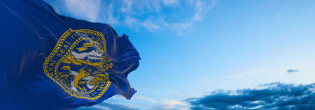 flag of Nebraska at cloudy sky background on sunset. Patriotic concept about state. 3d illustration,の写真素材
