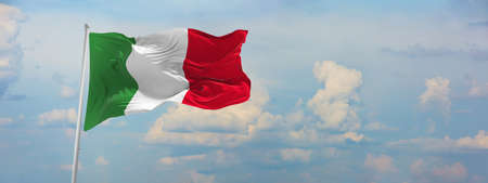flag of Italia at cloudy sky background on sunset, panoramic view. Patriotic concept about Italia and copy space for wide banner. 3d illustration,の写真素材