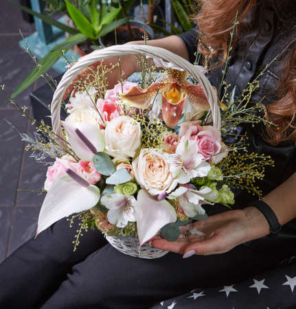 woman holding a beautiful colourful blossoming flower bouquet. Fresh, lush bouquet of colorful flowers.の写真素材