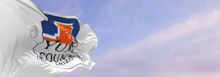 flag of county Yuma, Arizona , USA at cloudy sky background on sunset, panoramic view, Patriotic...