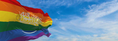 flag of LGBT, Saudi Arabia waving in the wind at cloudy sky. Freedom and love concept. Pride month....