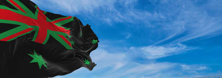 flag of African Americans of Australia state, untied states of America at cloudy sky background on sunset, panoramic view. copy space for wide banner. 3d illustrationの写真素材