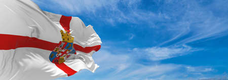 flag of Almeria Province , Spain at cloudy sky background on sunset, panoramic view. Spanish travel and patriot concept. copy space for wide banner. 3d illustrationの写真素材