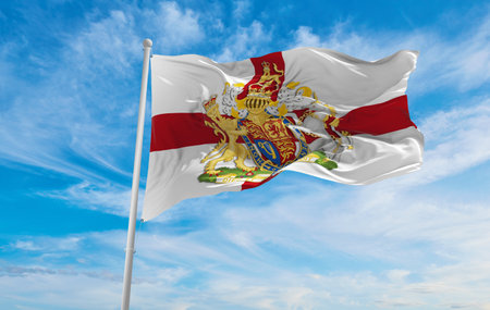 flag of Royal Arms of England  at cloudy sky background on sunset. panoramic view. united kingdom of great Britain, England. copy space for wide banner. 3d illustrationの写真素材