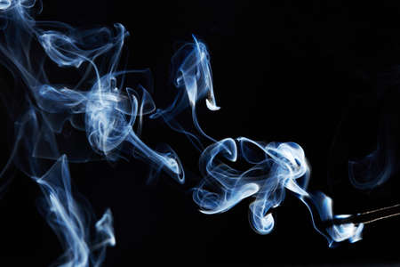 blue smoke on black background with abstract blur motion wave swirl . Wisp of Smoke. Cigarette smoke waves and clouds  textureの写真素材