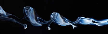 blue smoke on black background with abstract blur motion wave swirl . Wisp of Smoke. Cigarette smoke waves and clouds  textureの写真素材