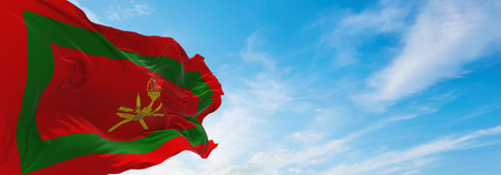 Royal Standard of Oman flag at cloudy sky background on sunset, panoramic view. Oman travel and patriot concept. copy space for wide banner. 3d illustrationの写真素材