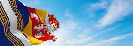 flag of Grand Est, France at cloudy sky background on sunset, panoramic view. French travel and patriot concept. copy space for wide banner. 3d illustrationの写真素材