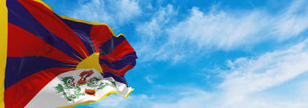 flag of Tibet at cloudy sky background on sunset, panoramic view. People's Republic of China. copy space for wide banner. 3d illustrationの写真素材