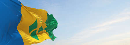 official flag of Curacao at cloudy sky background on sunset, panoramic view. travel and patriot...