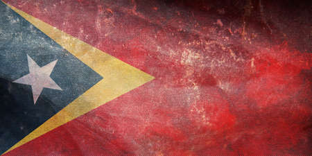 Top view of official retro flag Timor Leste with grunge texture. patriot and travel concept. no flagpole. Plane design, layout. Flag backgroundの写真素材