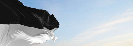 flag of Canton of Fribourg , Switzerland at cloudy sky background on sunset, panoramic view. Swiss travel and patriot concept. copy space for wide banner. 3d illustrationの写真素材