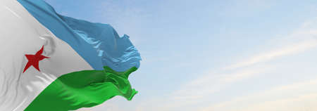 official flag of Djibouti at cloudy sky background on sunset, panoramic view. patriot and travel concept. copy space for wide banner. 3d illustrationの写真素材