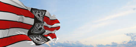 flag of Joao Pessoa , Brazil at cloudy sky background on sunset, panoramic view. Brazilian travel...