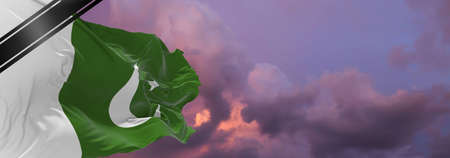 national flag of Pakistan with Mourning Ribbon. memory of victims of war, terrorist attack,...