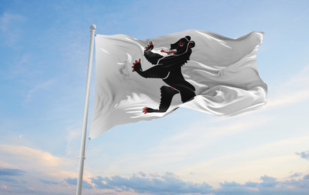 flag of Canton of Appenzell Innerrhoden , Switzerland at cloudy sky background on sunset, panoramic view. Swiss travel and patriot concept. copy space for wide banner. 3d illustrationの写真素材