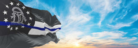 blue line flag of Georgia state, Usa at cloudy sky background on sunset, panoramic view. United...