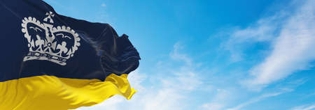 flag of Regina , Canada at cloudy sky background on sunset, panoramic view. Canadian travel and patriot concept. copy space for wide banner. 3d illustrationの写真素材